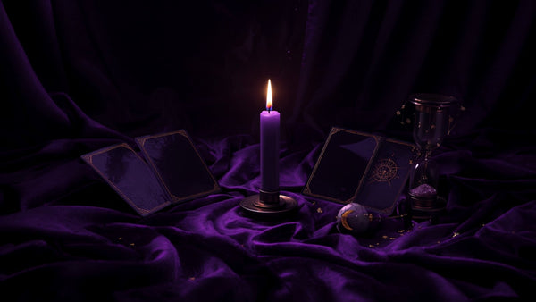 A crescent moon over a candlelit altar draped in violet